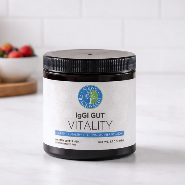 Supplement jar labeled 'IgGI Gut Vitality' on a white surface with a blurred background
